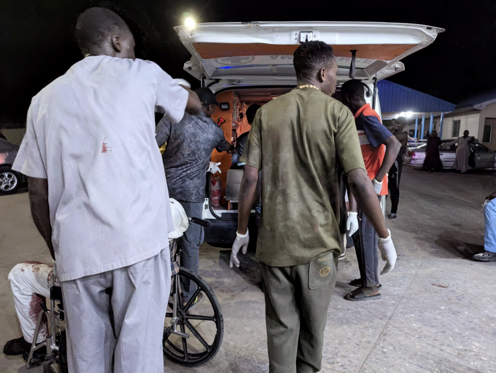 Members of the Nigerian Red Cross helping wounded victims into an ambulance. Photograph: Adewale Kolawole/Reuters